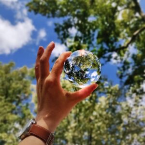 unknown person holding clear glass ball